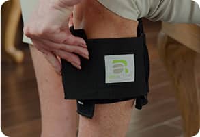 Older person applying pressure to the BeActive® Plus for more comfort around the knee